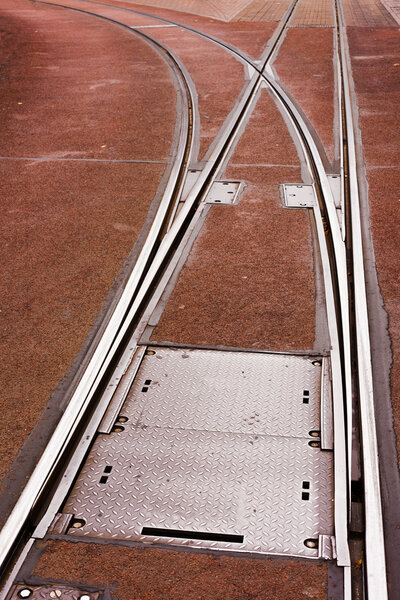 Tram rails and switch in pavement of city street