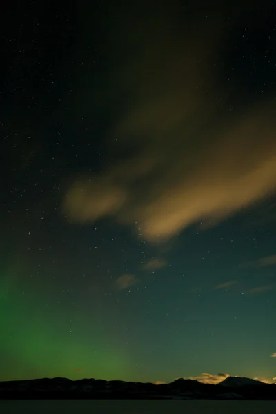 Cielo nocturno con luces boreales, nubes y luna naciente — Foto de Stock