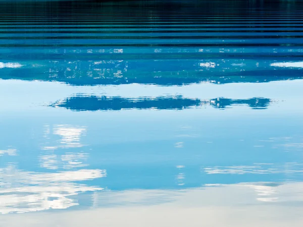 Wasseroberfläche spiegelt Landschaft abstrakt wider — Stockfoto