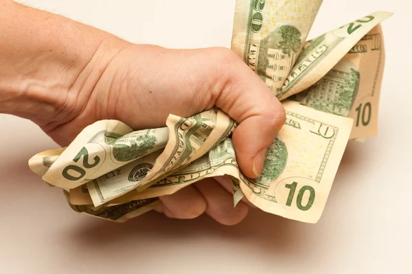 Fist Holding a Bunch of Crunched US Dollar Bills — Stock Photo, Image