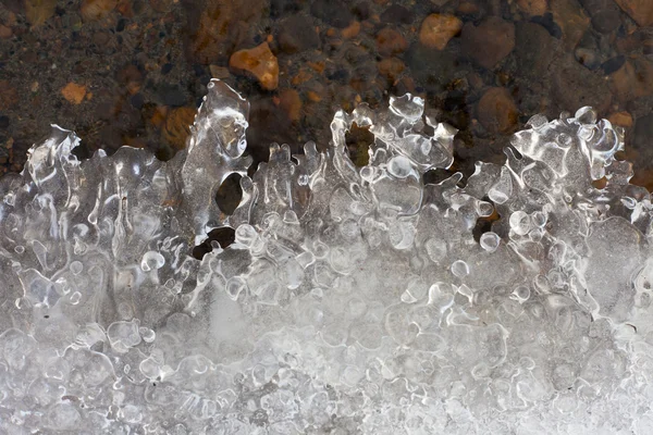 Duidelijk ijs vormen op de rand van water — Stockfoto