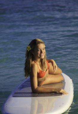 Teenage girl on a stand up paddle board