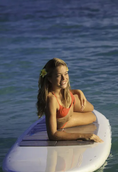 Teenage girl on a stand up paddle board — Stok fotoğraf