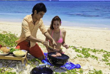 Couple having a barbecue clipart