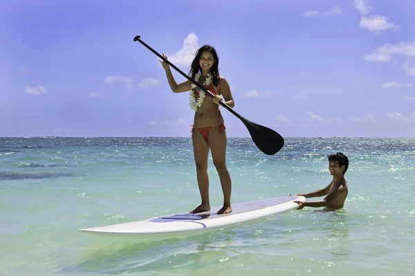 Young couple with their paddle board in hawaii — Stock Photo, Image