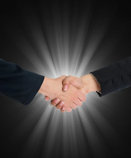 Handshaking in front of blue light — Stock Photo, Image