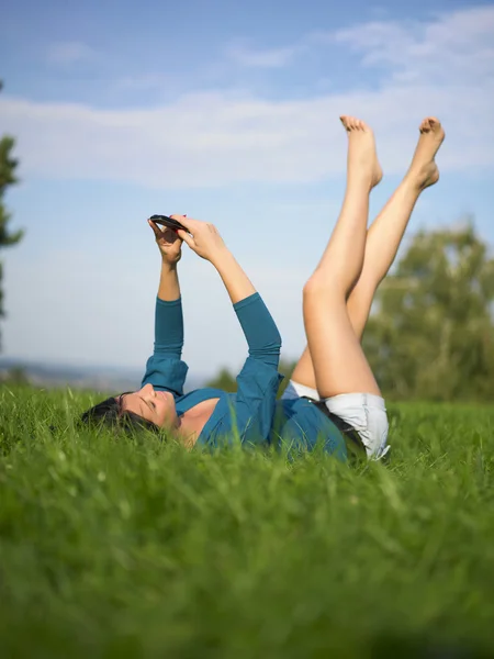 Young woman using laptop in park — Stock Photo, Image