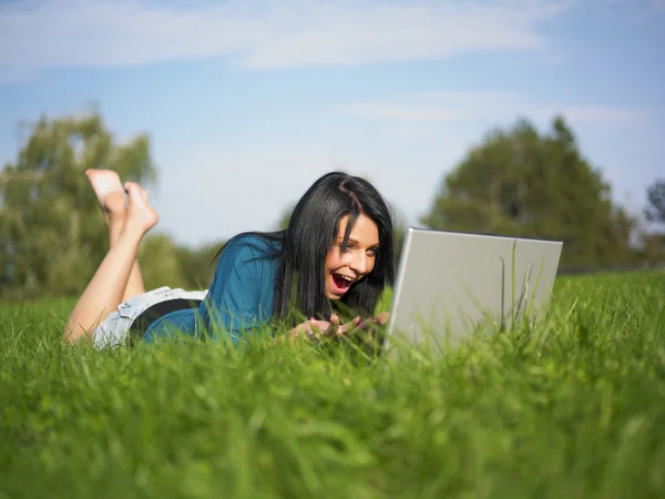 Jeune fille utilisant un ordinateur portable dans le parc — Photo
