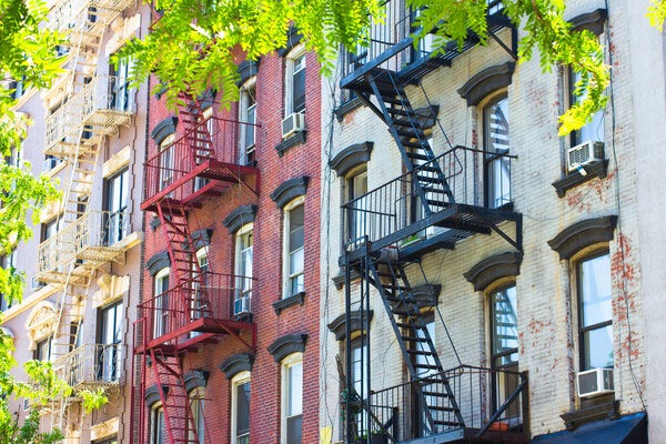 A row of historic New York City tenements from the 19th century