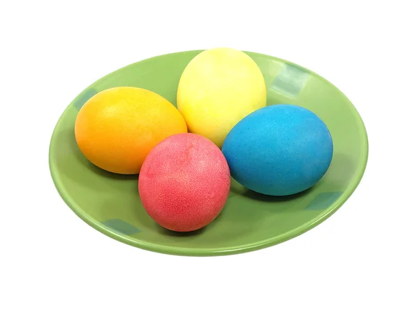 Multicolored eggs on a green plate. — Stock Photo, Image