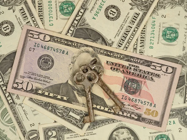 Metal keys on a dollar banknotes. — Stock Photo, Image