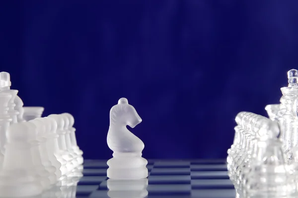Chess game figures on blue background