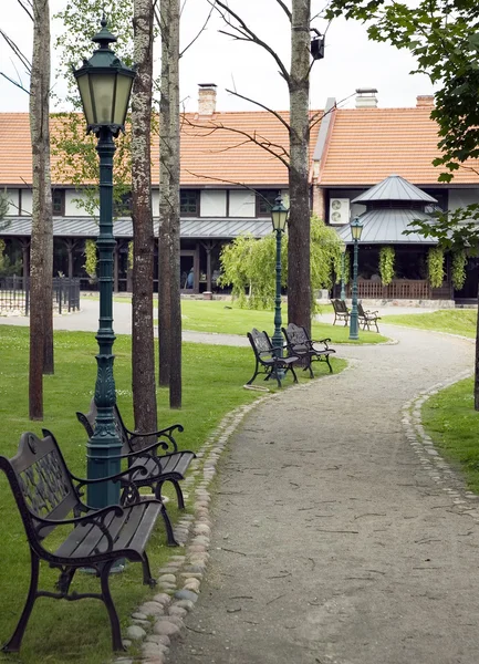 stock image Metal benches with wooden parts near the path