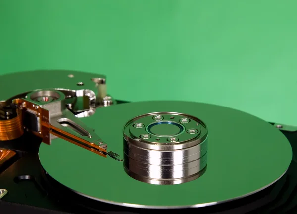 Inside of hard disc on green background — Stock Photo, Image