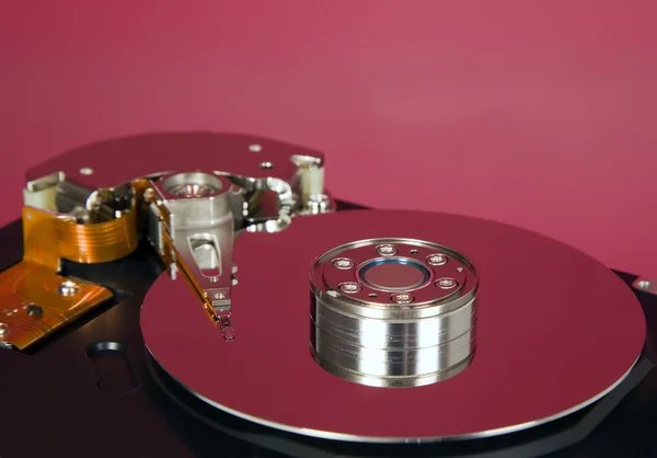 Inside of hard disc on red background — Stock Photo, Image