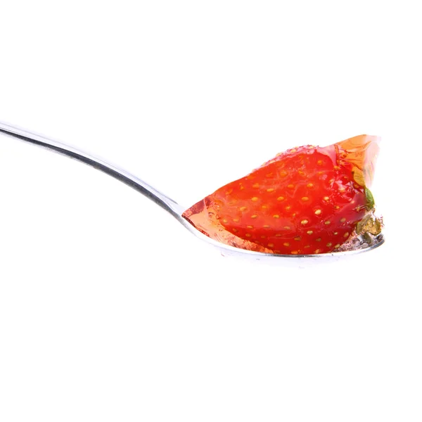 Strawberry jelly on a spoon — Stok fotoğraf