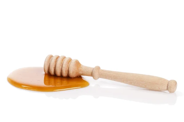 Honung strömstare i en pöl av honung — Stockfoto