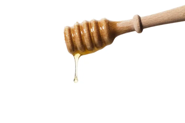 Honigtropfen aus einem Honiglöffel — Stockfoto