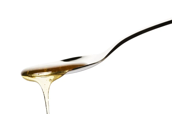 La miel cae de una cuchara — Foto de Stock