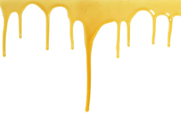 Honig fließt über einen weißen Hintergrund — Stockfoto