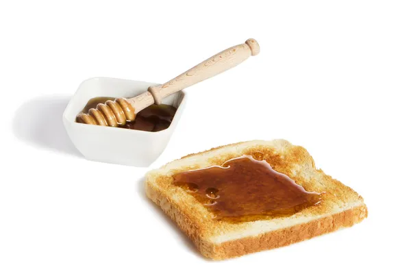 Brindis con miel y un tarro de miel con un cazo de miel —  Fotos de Stock