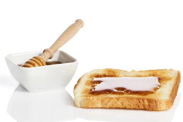 Toast mit Honig und ein Honigglas mit Honiglöffel — Stockfoto