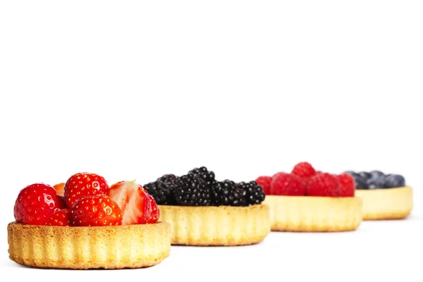 Strawberries in a tartlet in front of wild berries — Stock Photo, Image