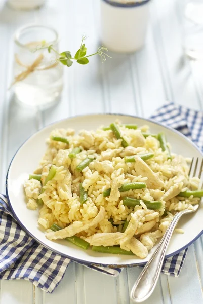 Rice with chicken and green beans on blue table — Stock Photo, Image