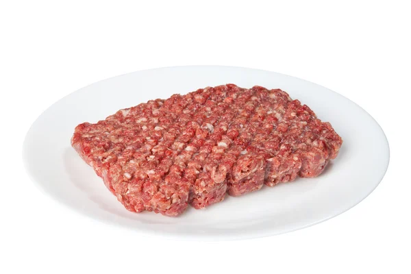 Carne crua em uma placa branca — Fotografia de Stock