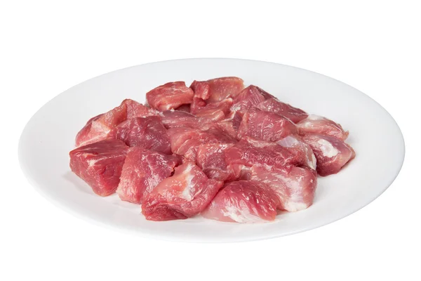 Pieces of raw meat on a white plate — Stok fotoğraf