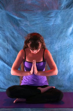 Woman in half lotus yoga prayer position clipart