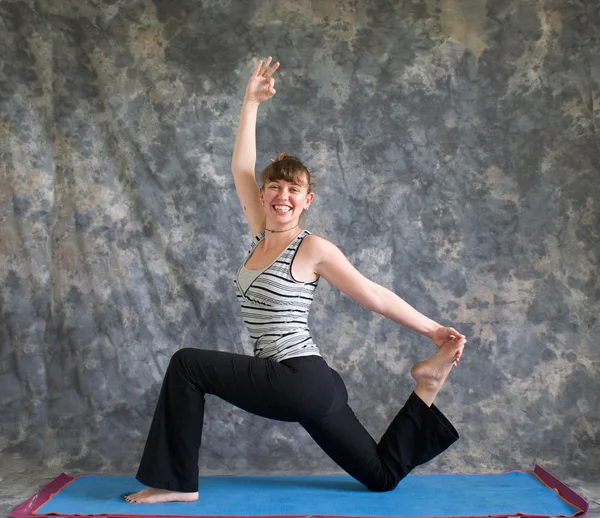 Woman doing Yoga posture King Arthurs pose variation — Stock Photo, Image