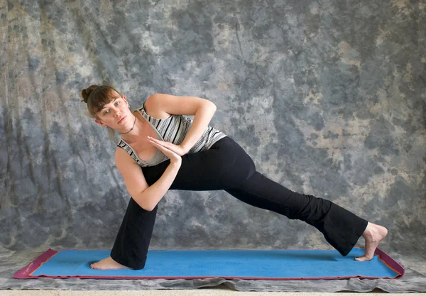 Woman doing Yoga posture Parivrtta Parsvakonasana or Revolved Ex — Stock Photo, Image