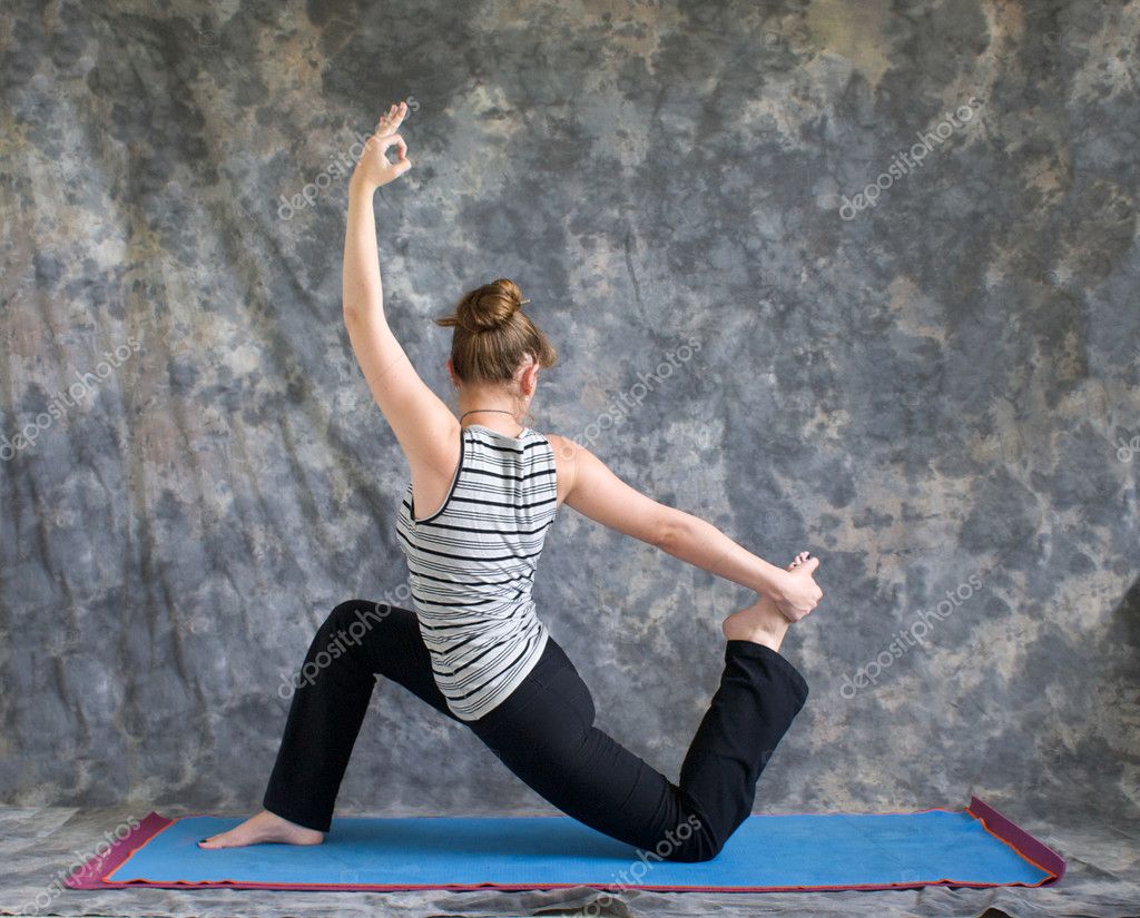 Woman doing Yoga posture King Arthurs pose variation — Stock Photo