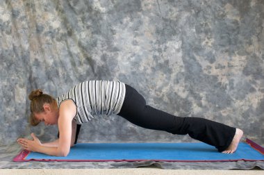 Woman doing Yoga posture Utthan Pristhasana or lizard pose clipart