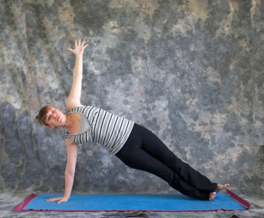 Yoga duruş vasisthasana veya yan tahta poz yapıyor kadın