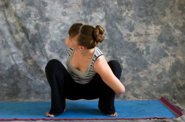 Young woman doing Yoga posture bound Malasana or garland squat p clipart