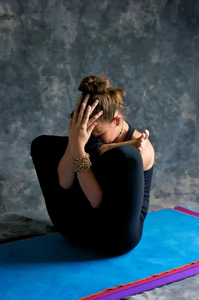 Yoga egzersiz rahmine embriyo duruş veya garbha pindasan yapıyor kadın — Stok fotoğraf