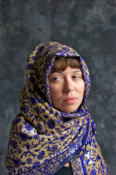 stock image Sad looking woman wrapped in shawl