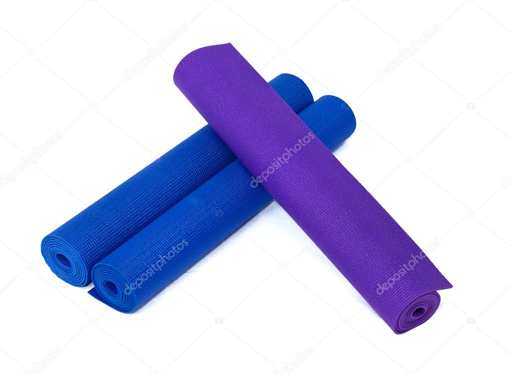 Three rolled yoga exercise mats on white