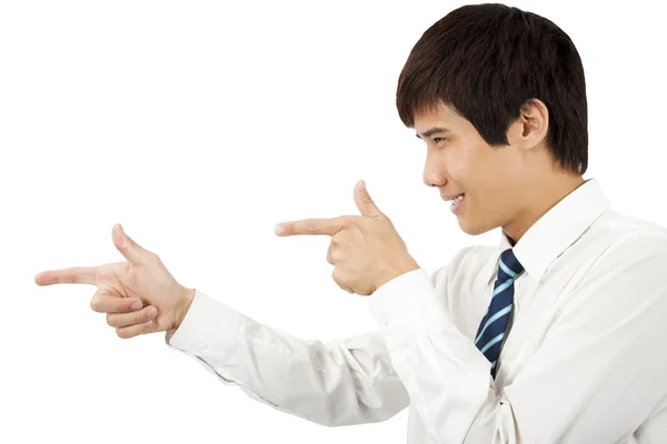 Portrait of an smiling young business man pointing at against white backgro — Stock Photo, Image