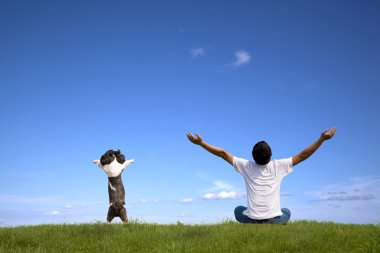 Young man with dog relaxed on summer times clipart