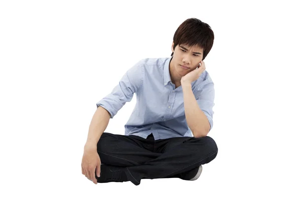 Upset young man sitting on the floor — Stock Photo, Image