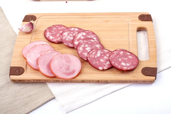 Salami slicing naast knoflook — Stockfoto