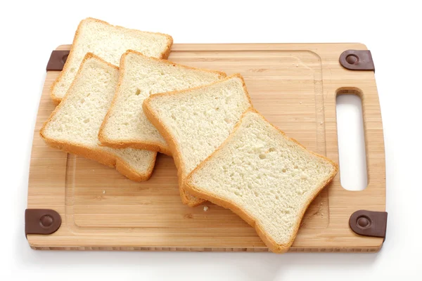 stock image Fresh sliced loaf of bread on wooden chopping board