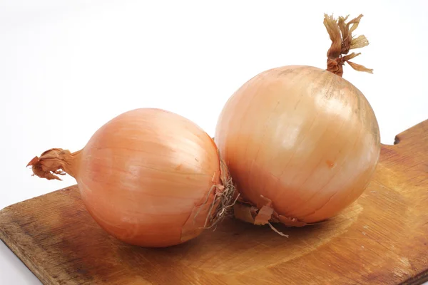 stock image Onions on a wooden board