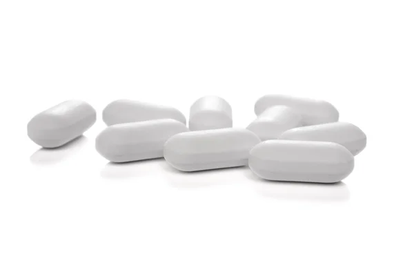 Białe tabletki medyczne ponad białe — Zdjęcie stockowe