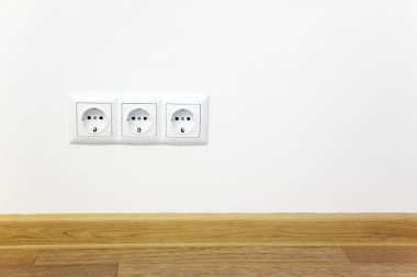 Empty interior white wall with power outlet clipart