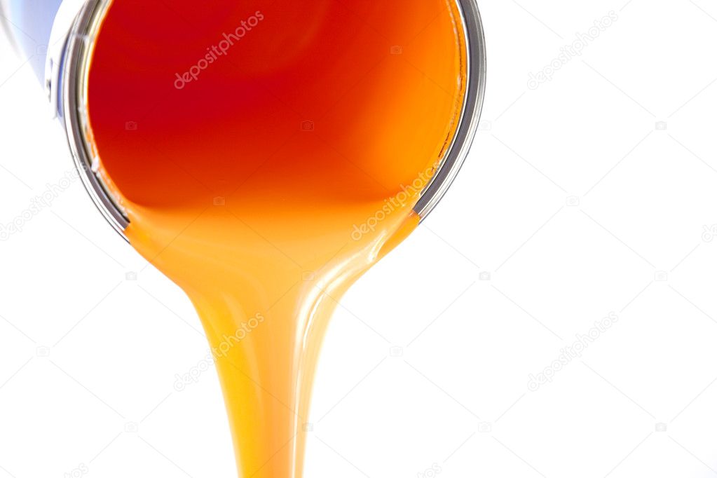Orange paint flows from the bucket / isolated on white / photo