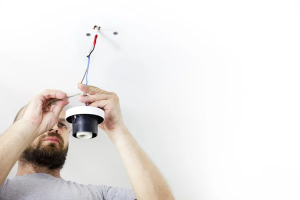 stock image Electrician Installing Celling Light / House worker / Repairman